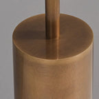 Close view of the brushed bronze cylinder base where the slim stem meets it, on this Clérachic floor lamp.