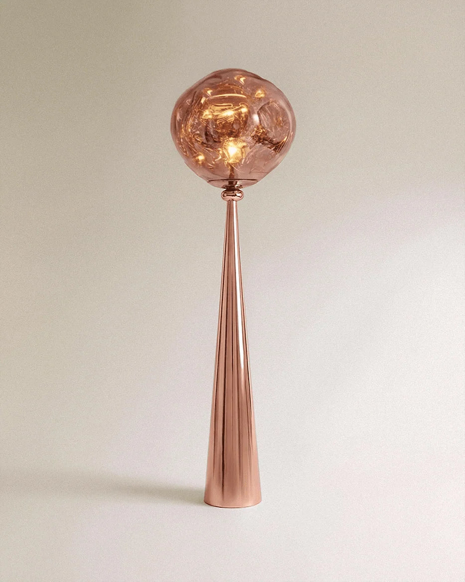 Clérachic floor lamp with a polished rose gold cone stem and a rippled blush shade glowing warm.