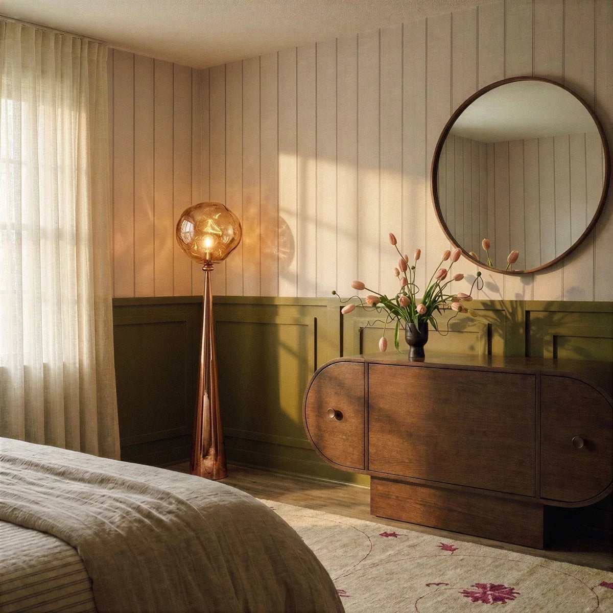 Clérachic rose gold floor lamp glowing in a bedroom with striped panelling, olive wainscot and a round wall mirror.