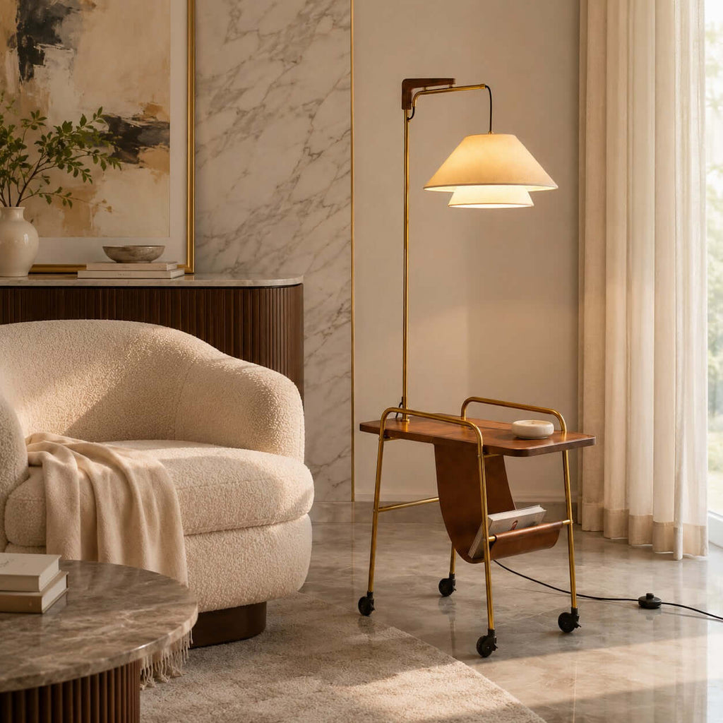 Clérachic floor lamp with a brass frame and a walnut-toned tabletop, next to a bouclé armchair and a marble-topped table.