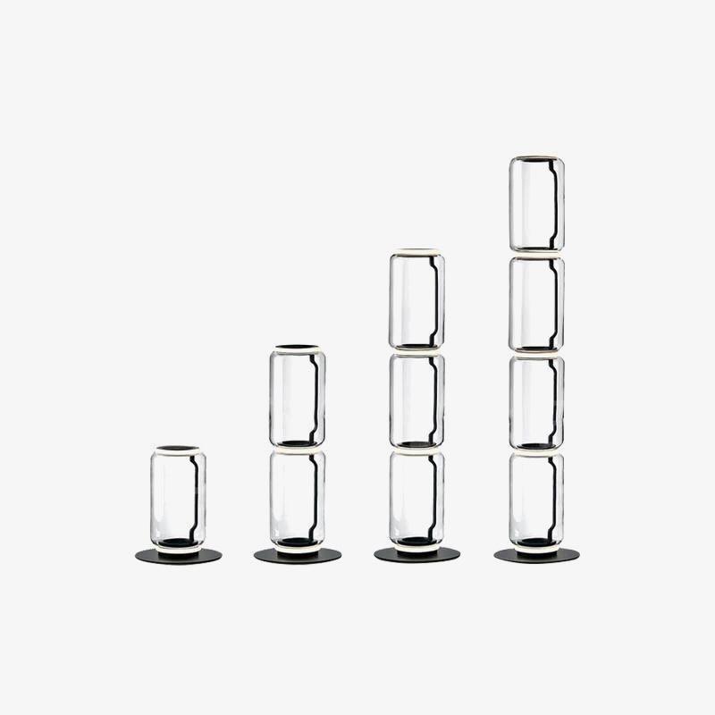 Four Clérachic glass floor lamp heights side by side on a white backdrop, from a single cylinder up to a stack of four.