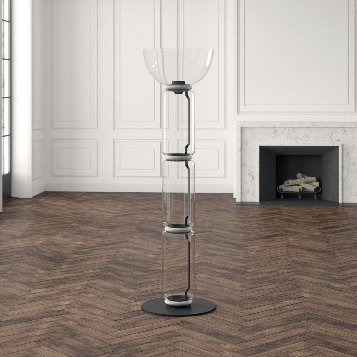 Unlit Clérachic glass floor lamp with a bowl top on a herringbone floor, in a white panelled room with a stone fireplace.