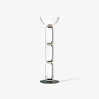 Clérachic glass floor lamp on white with three clear cylinders and a wide bowl shade, a soft shadow trailing on the floor.
