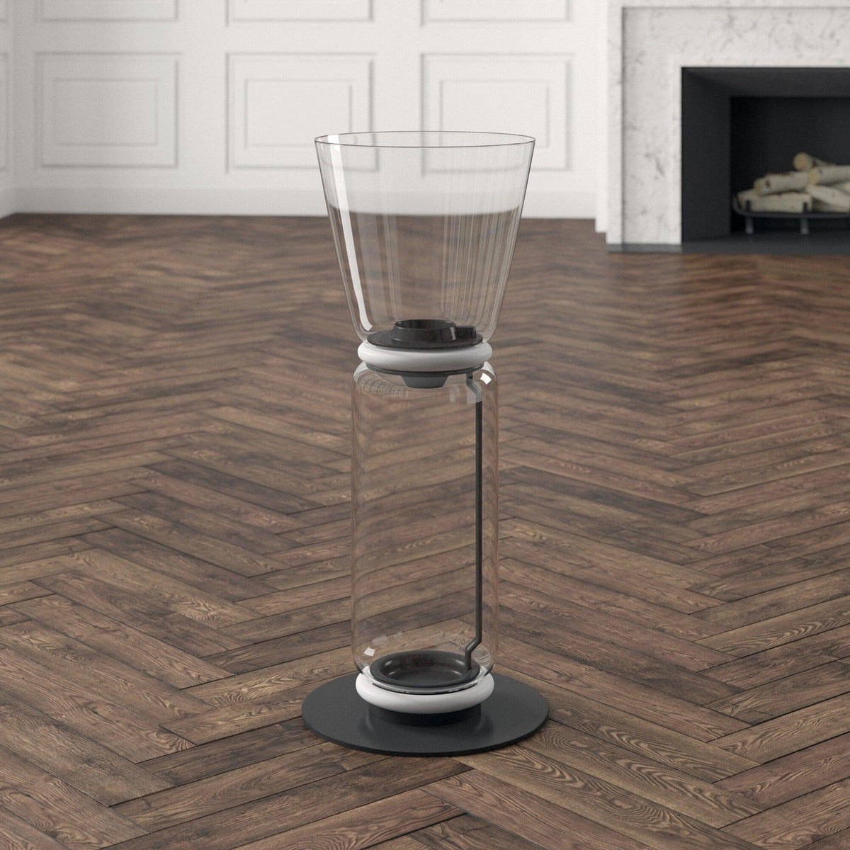 Close view of the cone shade and clear glass cylinder of this Clérachic floor lamp on a herringbone floor, with a white ring between them.