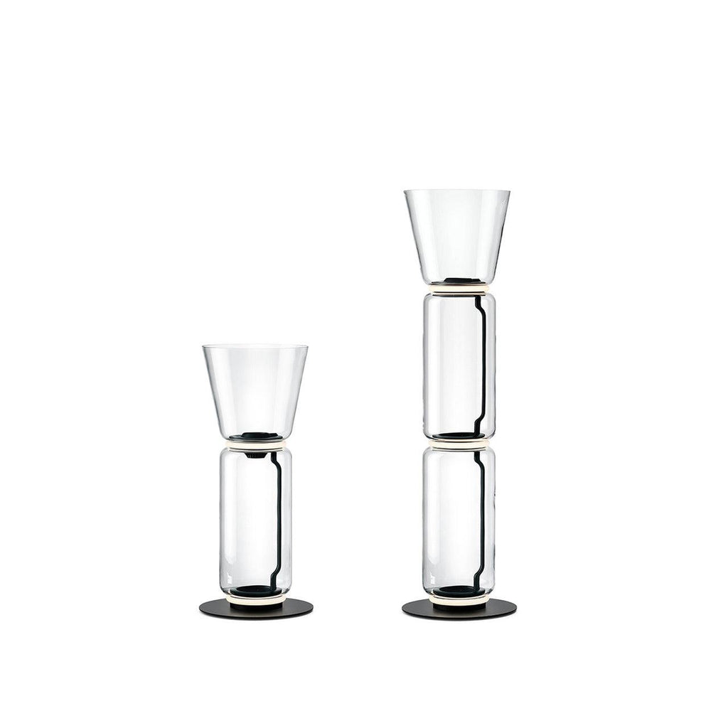 Two Clérachic glass floor lamps with cone shades on white, one a single cylinder and one a taller stack.