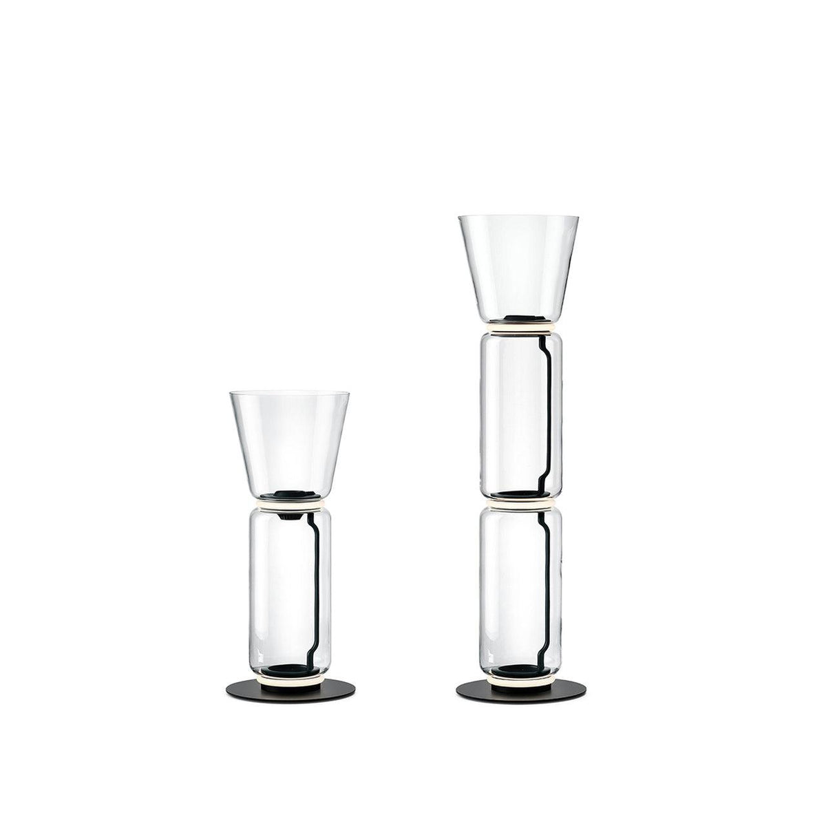 Two Clérachic glass floor lamps with cone shades on white, one a single cylinder and one a taller stack.