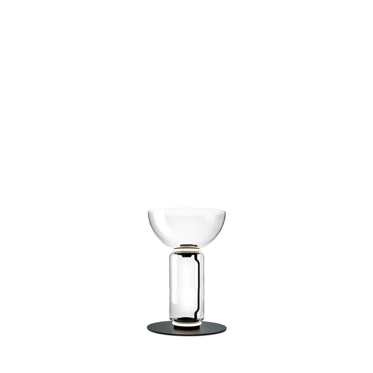 Short Clérachic glass floor lamp with a bowl shade over one clear cylinder, on a round black base against white.