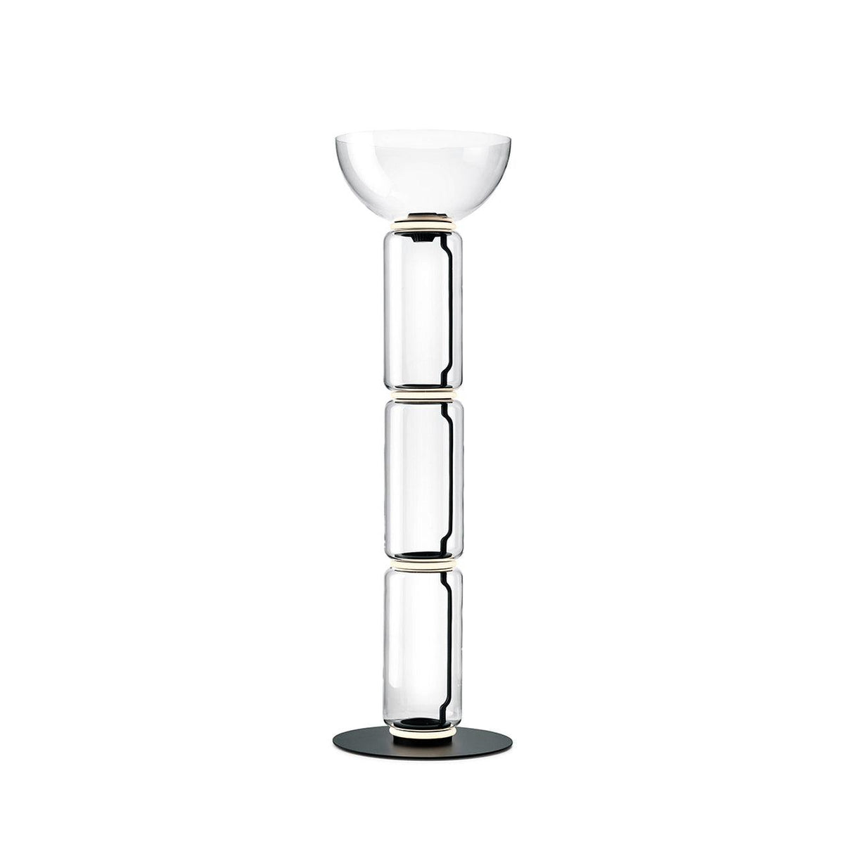 A Clérachic glass floor lamp with a bowl shade over three clear cylinders and a thin glowing ring at each joint, on white.