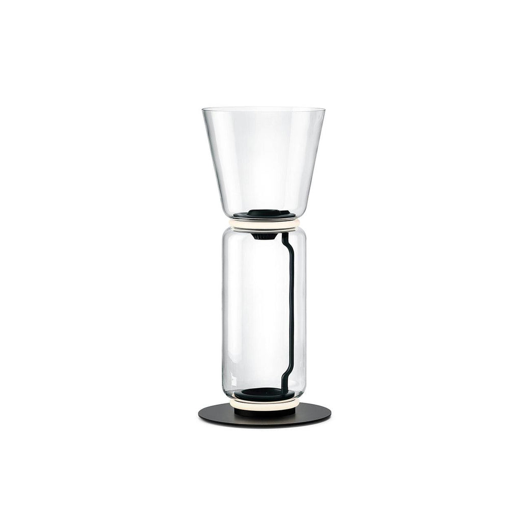 Clérachic glass floor lamp with a wide cone shade over a single large clear cylinder on a black base, on a white backdrop.