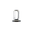 Clérachic table-height glass lamp with one clear cylinder and a lit ring at the top, on a round black base against white.