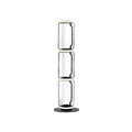 Clérachic glass floor lamp with three stacked clear cylinders and a ring at the top, on a black round base against white.