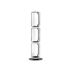 Clérachic glass floor lamp with three stacked clear cylinders and a ring at the top, on a black round base against white.