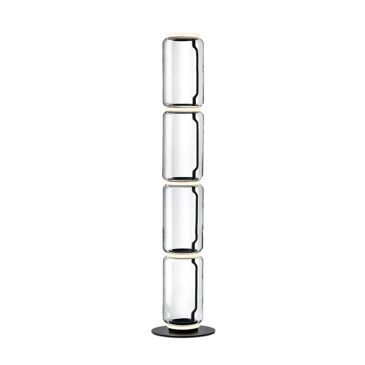 Clérachic glass floor lamp with four stacked clear cylinders and a black cord inside, on a round black base against white.