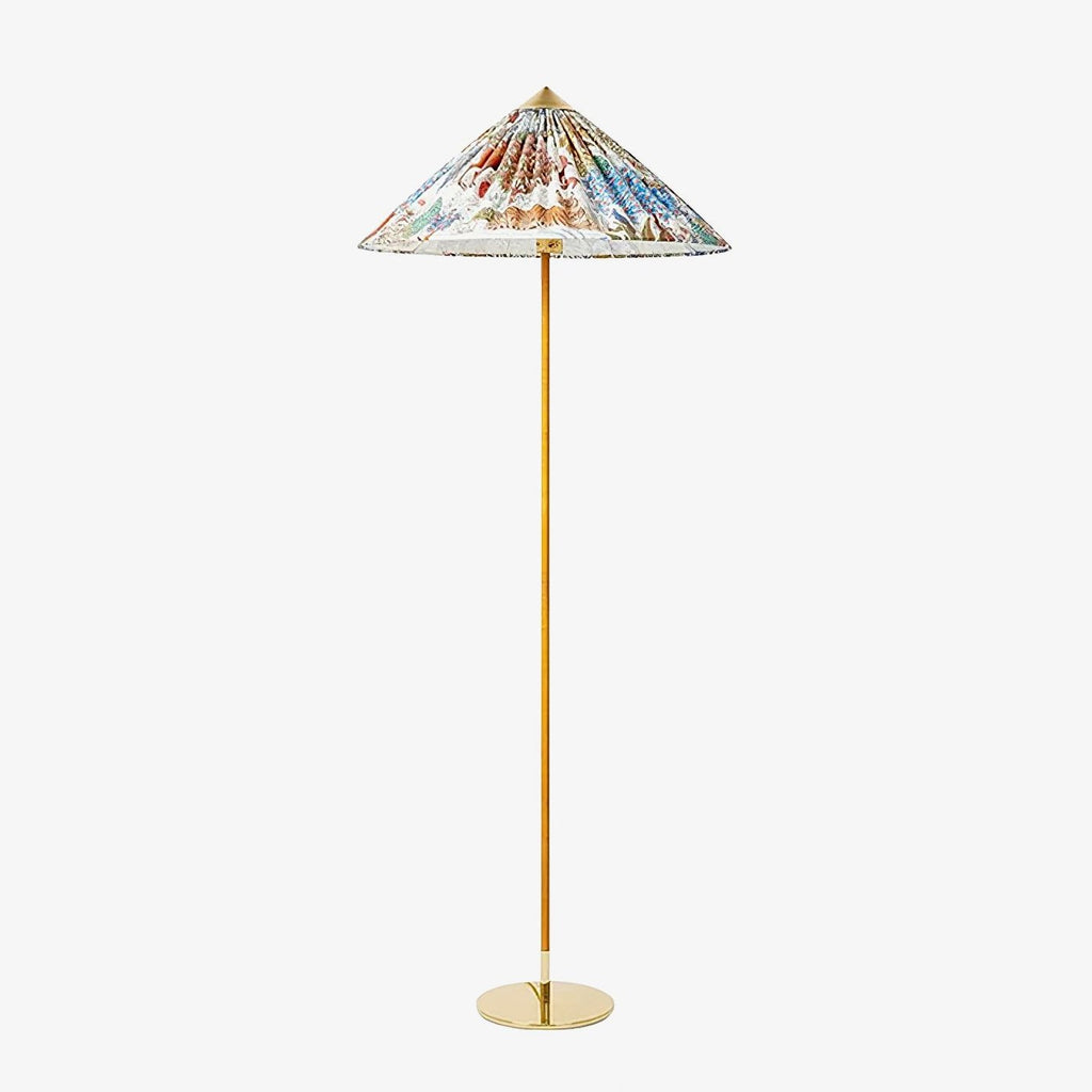 This Clérachic floor lamp on a plain white backdrop, with a wide conical shade printed with a colourful floral pattern on a slim brass stem.