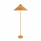 Clérachic floor lamp with a natural woven shade and a slim brass stem on a round brass base, on a plain white backdrop.