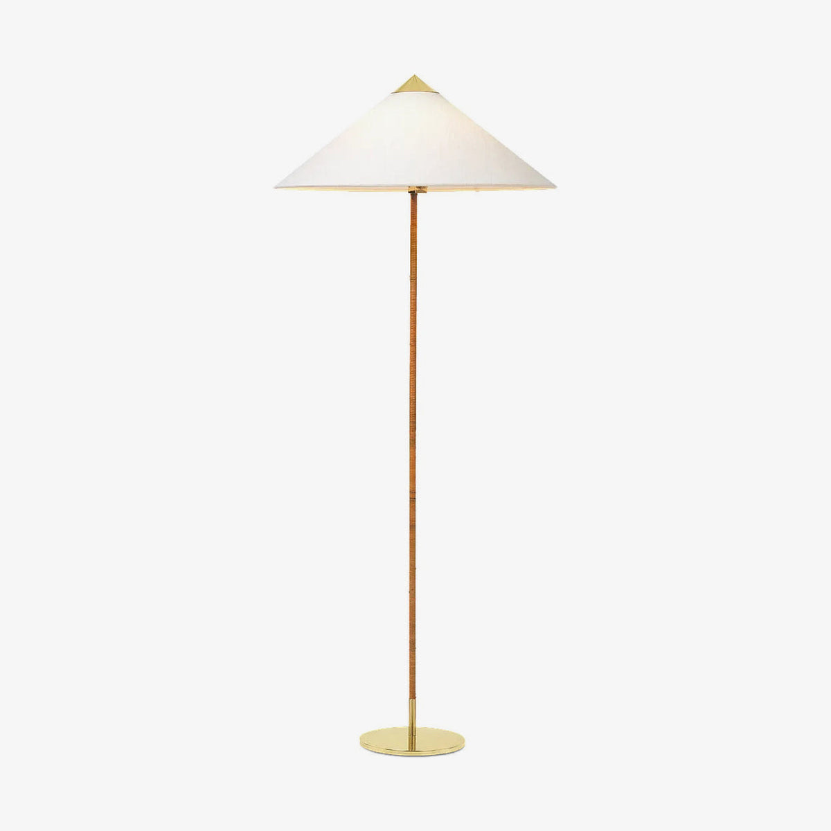 Front view of this Clérachic floor lamp with a white conical shade, a rattan-wrapped stem and a round brass base on a plain backdrop.
