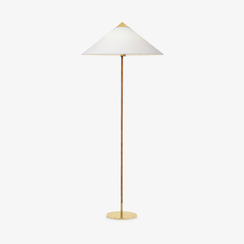 Shown here, a Clérachic floor lamp with a white fabric shade and a cane-wrapped stem, shown on a plain light backdrop, with a brass cap and foot.