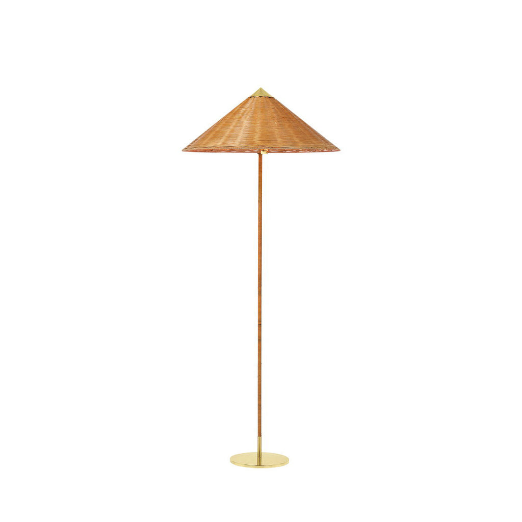 This Clérachic floor lamp with a woven rattan shade and a cane-wrapped stem on a brass base, on a plain white backdrop.