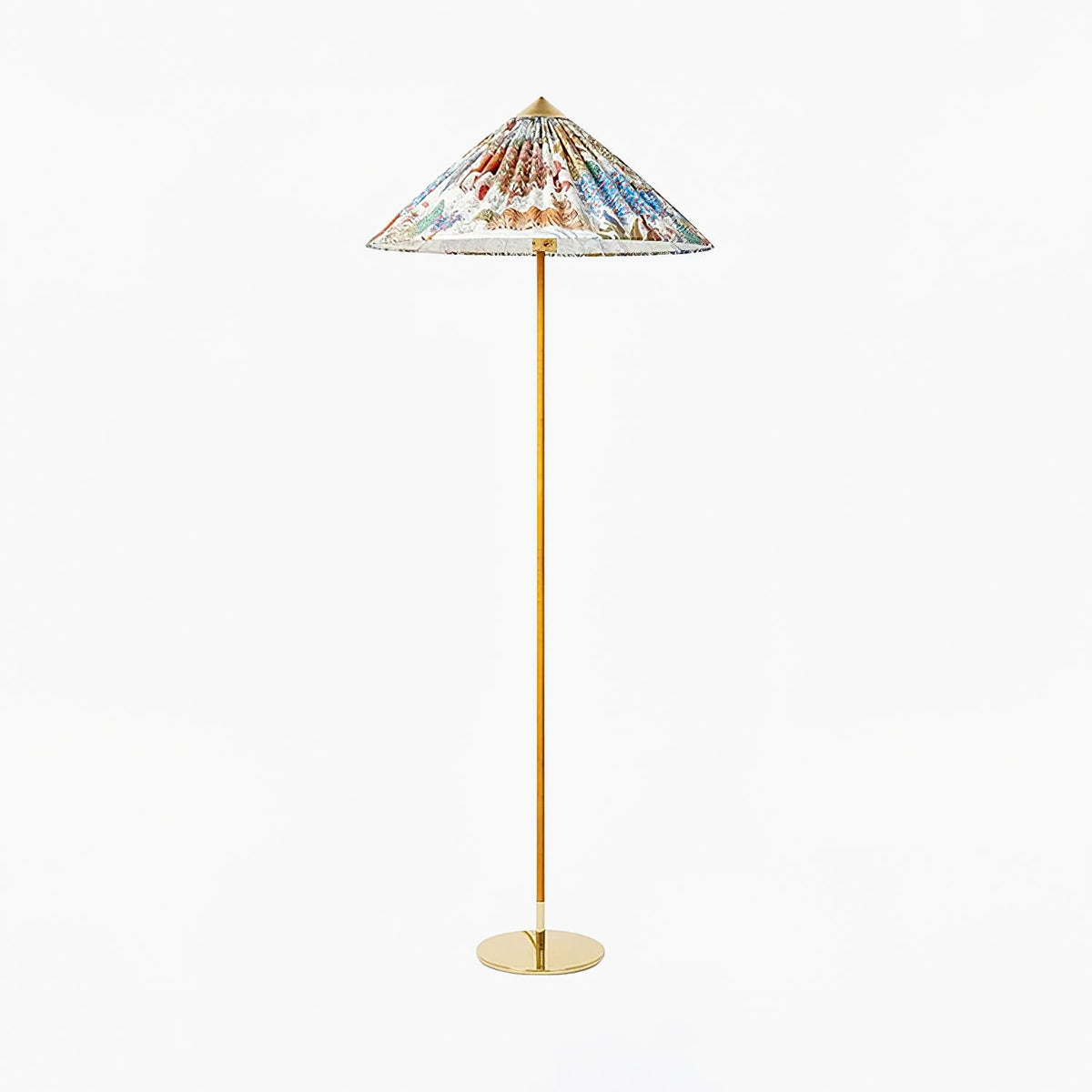 Clérachic floor lamp with a bright floral printed shade, a cane-wrapped stem and a brass base, on a white backdrop.