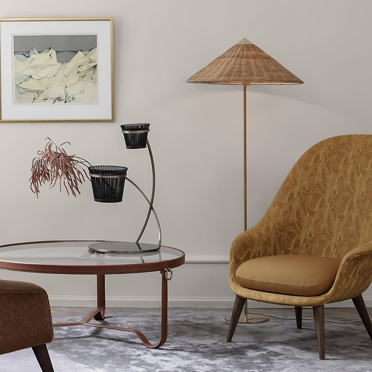 Clérachic floor lamp with a woven rattan shade beside an ochre armchair and a round glass coffee table, in front of a framed print.