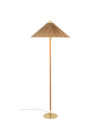A Clérachic floor lamp with a bamboo slat shade, a cane-wrapped stem and a brass base, on a green backdrop.
