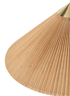 Close view of the bamboo slat shade of this Clérachic floor lamp against a green backdrop, with a brass cap at the top.