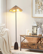 This Clérachic floor lamp's lit raffia shade stands over a rustic wooden console with a basket, a lantern and a cream throw.