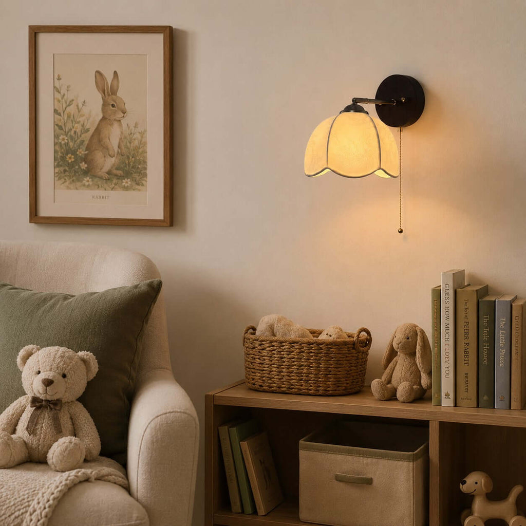 Clérachic scalloped-shade wall light in a child's reading corner, with a teddy bear, a basket and a low wooden shelf.