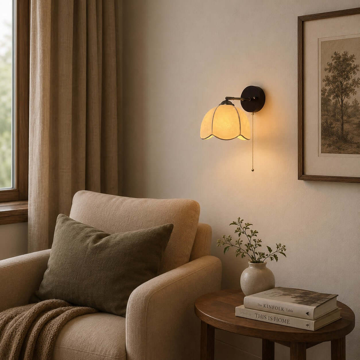 Clérachic wall light with a pull chain above a cream armchair and a round side table, by a window with linen curtains.