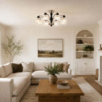 Clérachic glass-shade chandelier over a cream corner sofa and a wooden coffee table, with a built-in alcove shelf behind.
