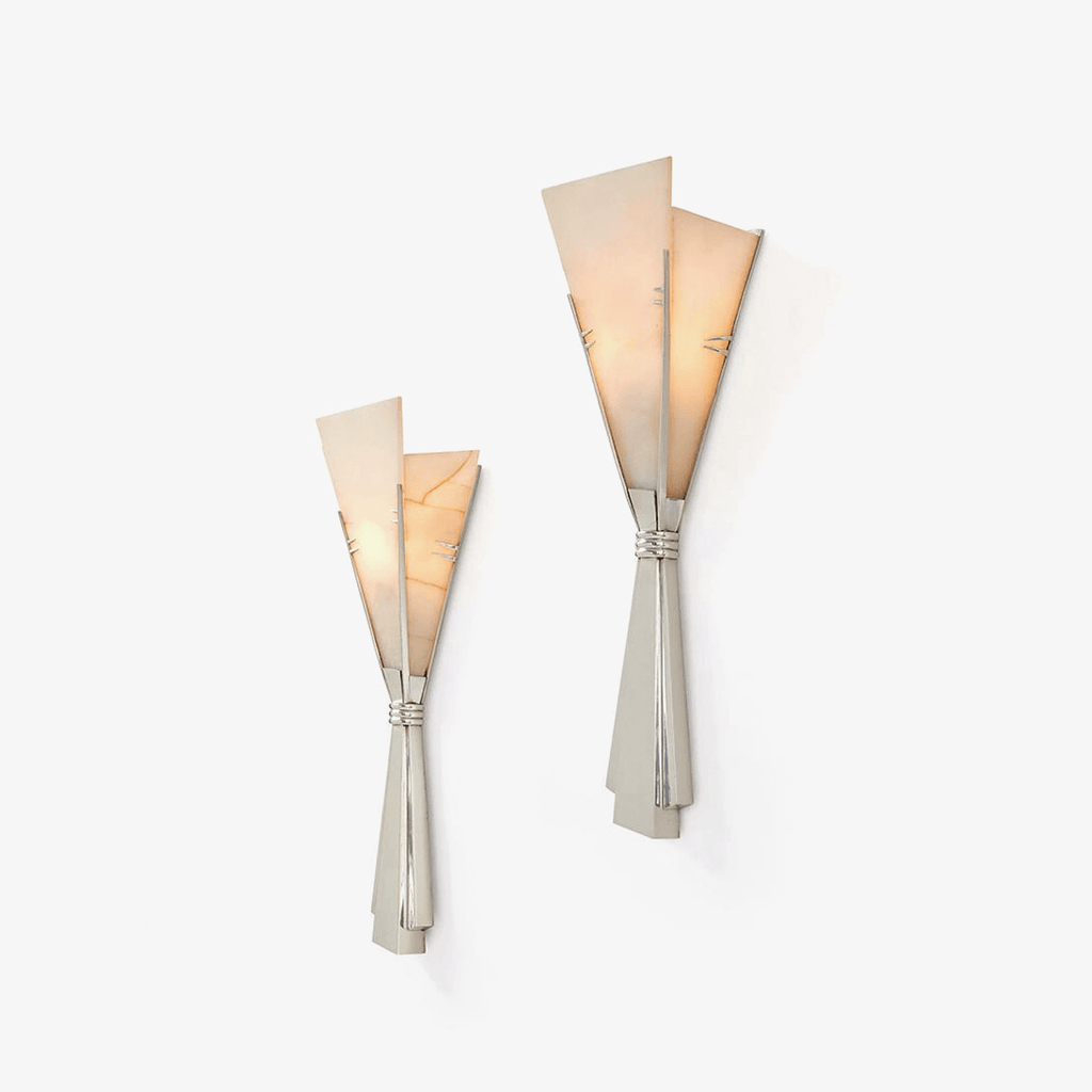 Two sizes of the Clérachic Florent sconce side by side, both lit warm on a white wall.
