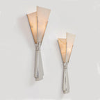 Two Clérachic Florent sconces on a white wall, angled to show the stepped fan panels.