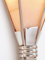 Macro of the Clérachic Florent shade top, chrome ribs meeting the warm stone panels.