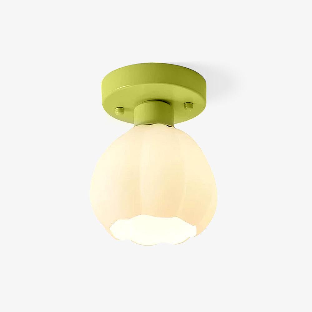 This Clérachic semi-flush ceiling light on a plain backdrop, with a green round canopy and a white ribbed glass shade shaped like a flower bud.