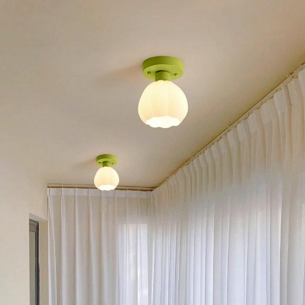 Two Clérachic semi-flush lights glow warm on a cream ceiling, one near and one further along a wall of sheer white curtains.