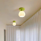 Two Clérachic semi-flush lights glow warm on a cream ceiling, one near and one further along a wall of sheer white curtains.
