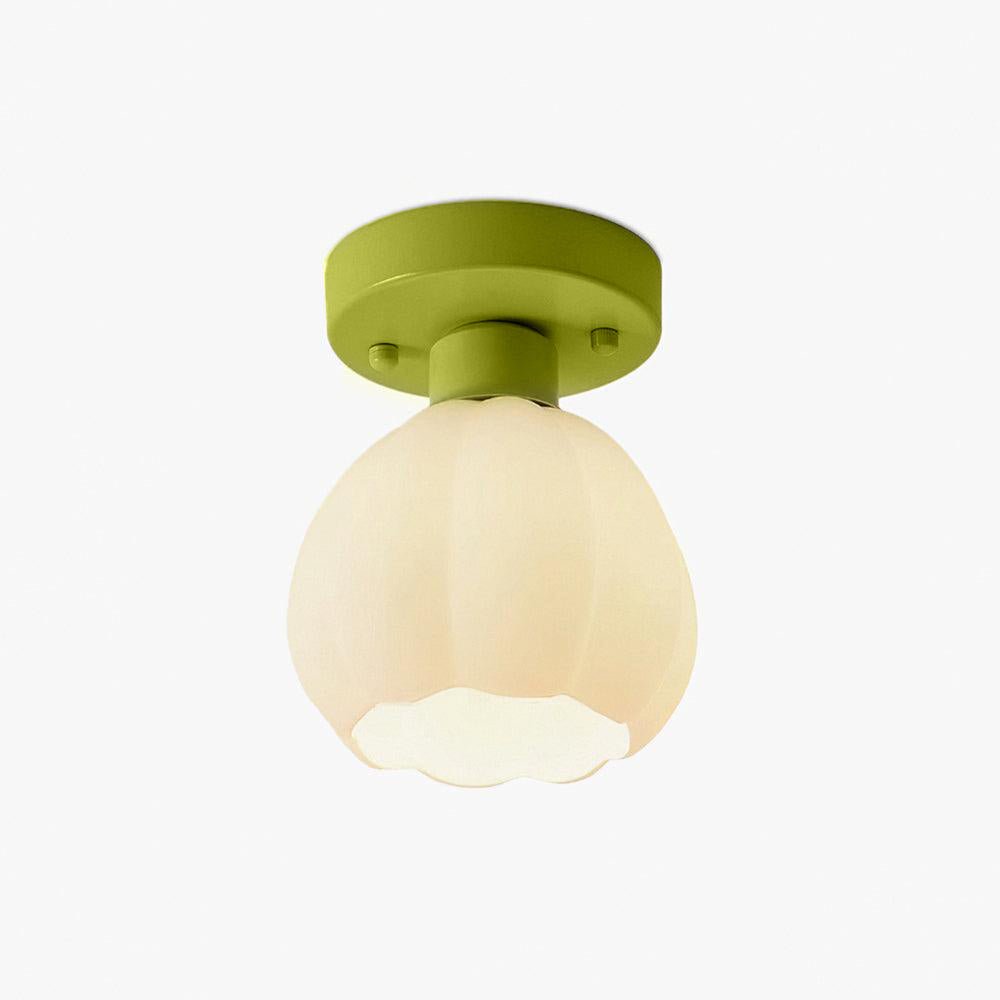 A Clérachic semi-flush light with a green canopy and a warm-toned ribbed glass shade, with a scalloped rim, on a plain backdrop.
