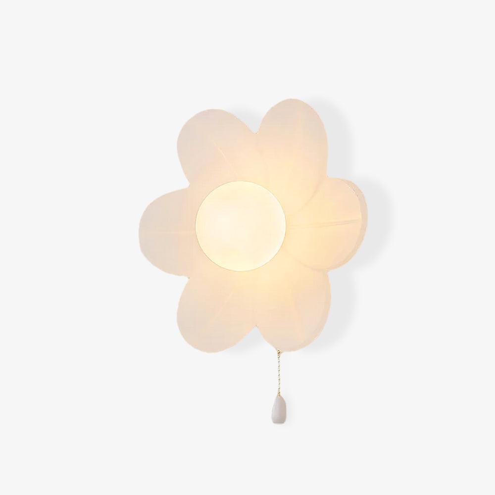 Clérachic flower wall light on a plain pale backdrop, with white petals, a frosted globe and a chain pull ending in a white drop.