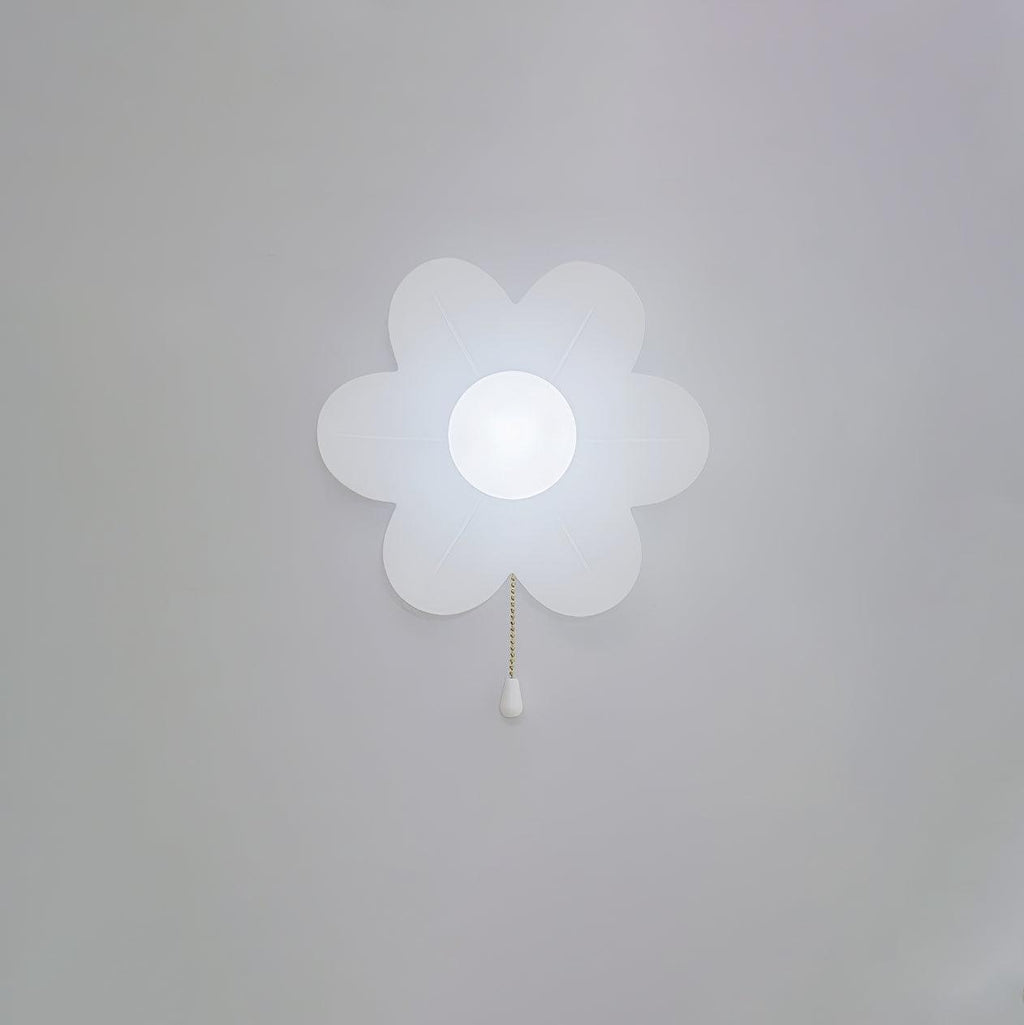 Cool white light from this Clérachic flower wall light on a pale grey wall, the frosted petals and globe glowing bluish-white.