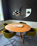 Clérachic's Flowerpot pendant in the Zebra Print finish, hung beside a round mirror on a dark wall.