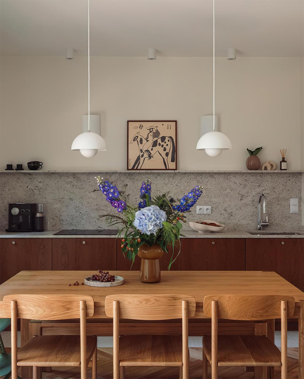 The Clérachic Flowerpot pendant in white, two shades hung side by side over a long dining table.