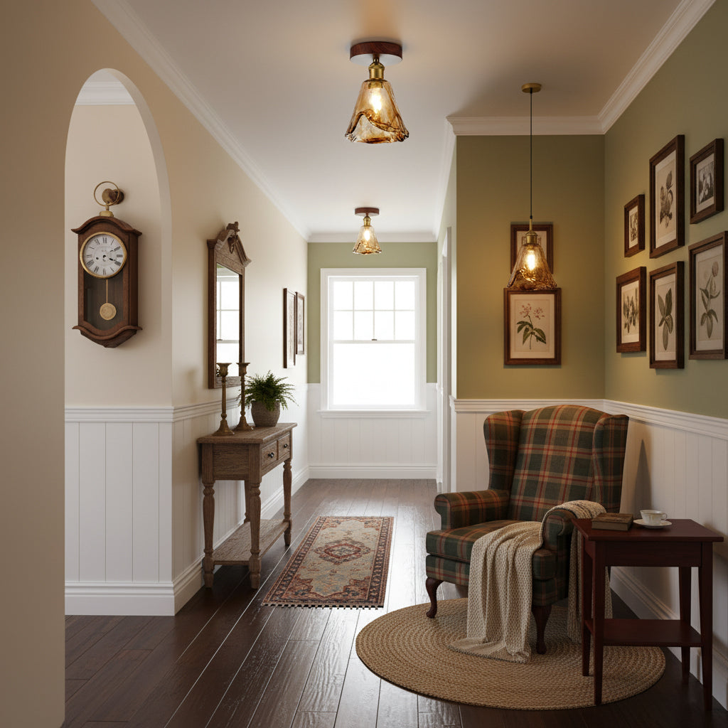 Two amber glass flush lights from Clérachic and a pendant, lit, in a hallway with a tartan armchair, framed botanical prints and a round rug.