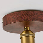 Close view of the walnut-effect canopy, brass knurled socket collar and screw fixing on this Clérachic flush ceiling light.