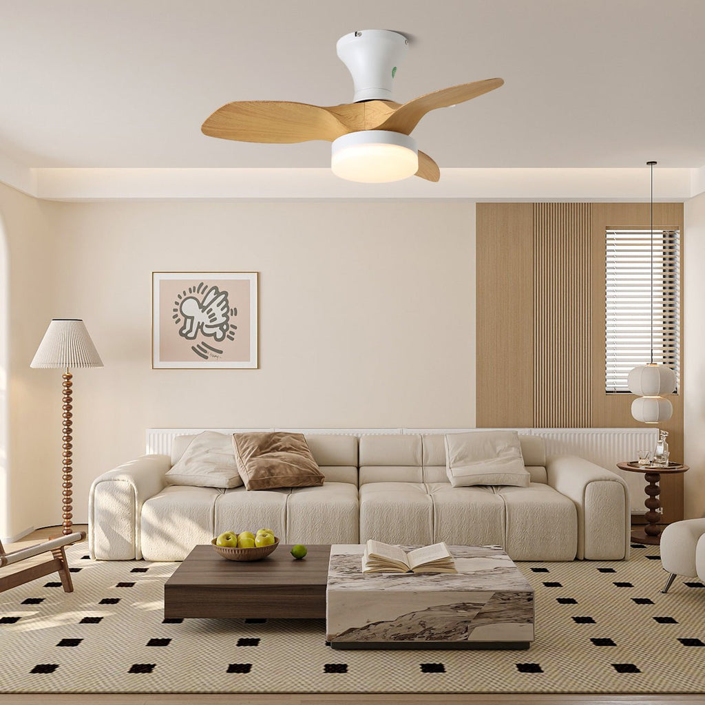 A Clérachic ceiling fan with light mounted high in a calm living room, above a cream sofa and low coffee table.