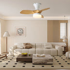 A Clérachic ceiling fan with light mounted high in a calm living room, above a cream sofa and low coffee table.
