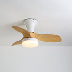 Angled view of this Clérachic ceiling fan, a white canopy and round warm-lit light under three pale wood-grain blades.