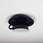 Clérachic's black ceramic coffee-cup light shows its glossy glaze and looped handle up close.