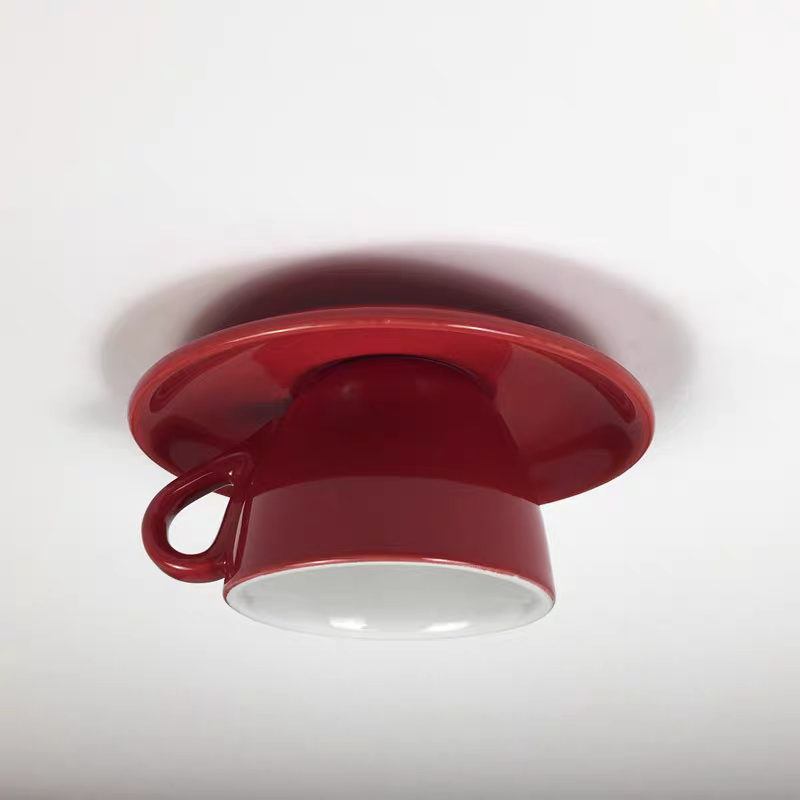 Clérachic's red coffee-cup ceiling light shows its rounded saucer base and curved handle.