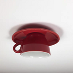Clérachic's red coffee-cup ceiling light shows its rounded saucer base and curved handle.