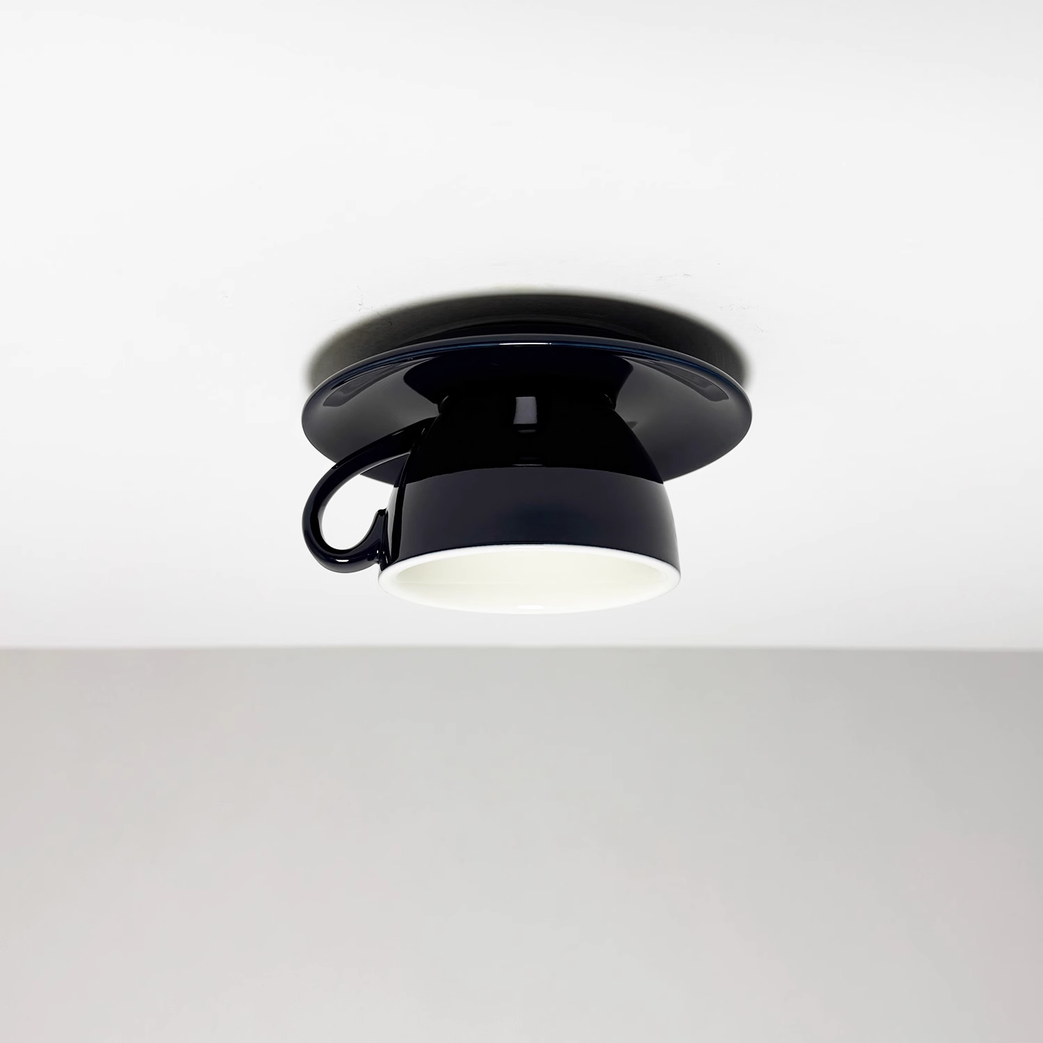 Clérachic's navy coffee-cup flush mount shows the deep glaze catching light from below.
